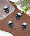 Four Kickass Punk Skull Screw Back Brass Rivets For Leather Crafting Hardware on brown leather background.
