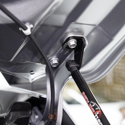 Close-up of Hood QuickLIFT System for Toyota Tacoma and 4Runner, showing the sleek aluminum mount and installation detail.