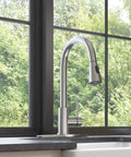 YZZY Single Handle Kitchen Sink Faucet with Pull Down Sprayer Stainless Steel Single Hole Bar Faucet High Arc Chrome Pull Out Kitchen Faucet by a window.