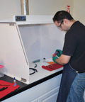 Person using Heavy-Duty 40-Inch Wide Ducted Fume Hood With 6-Inch Exhaust Collar And LED Lighting For Lab Fume Control