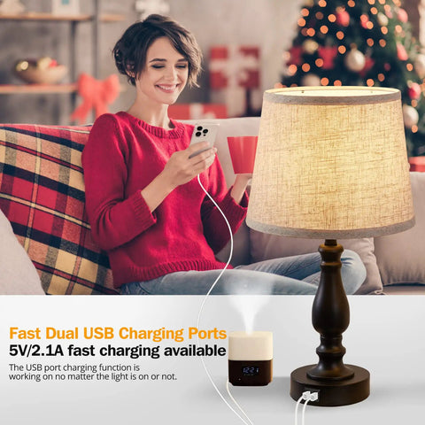 Cool Set Of 2 Table Lamps With USB Ports, Dimmable Touch Control, linen lampshade on a table beside a woman using a phone.