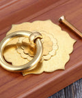 Antique Brass Ring Pulls For Cabinets And Doors Hexagon Flower Design on wood surface with installation screw