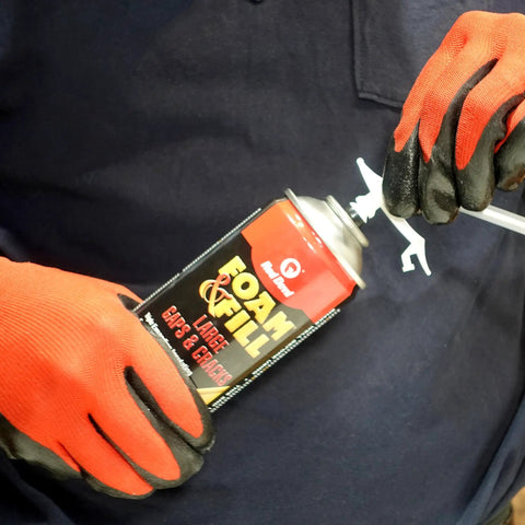 Person using Tough As Nails Expanding Spray Foam Insulation Sealant For Large Gaps And Cracks, 12 Oz Off White Polyurethane.