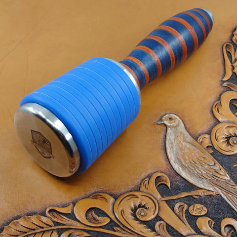 Professional Leather Tooling Maul With Tough Nylon Head And Real Veg Tan Leather Handle Stainless Steel Hardware For Stamping And Embossing, close-up on leather background.