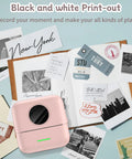 No Sweat Portable Mini Sticker Printer And Slick Inkless Thermal Maker With Effortless Bluetooth Sync For Quick Journaling Labels on a desk with prints.
