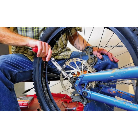 Person using Quarter Inch Drive Ratcheting T Handle Torque Wrench With 20 To 100 Inch Pound Range on bike wheel