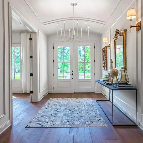 8 Light Rustic Industrial Chandeliers With Brushed Nickel Finish in elegant foyer with natural light and modern decor.
