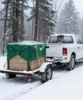 Truck towing a snow-covered trailer secured with Six Pack 2 Inch By 15 Foot Heavy Duty Ratchet Straps With Double J Hooks