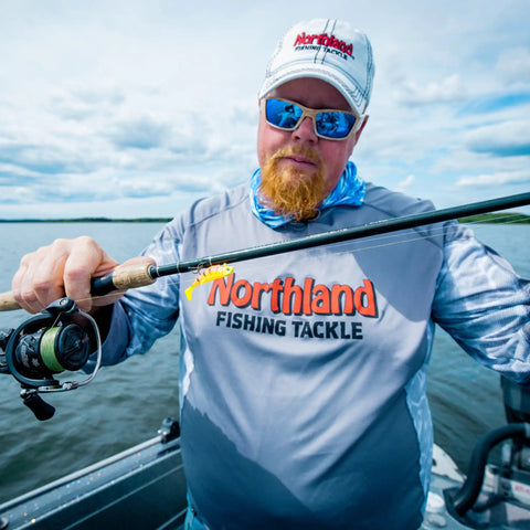Man holding fishing rod with Mimic Minnow Swimbait Lure Kit With Jig Head Design Assorted Sizes And Colors For Walleye Bass Pike