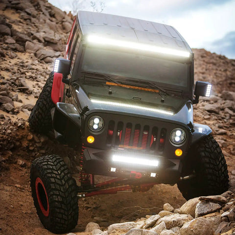 Off-road vehicle with 12 Inch 300W Triple Row LED Light Bar Flood And Spot Combo With 30000LM, shown on rocky terrain.