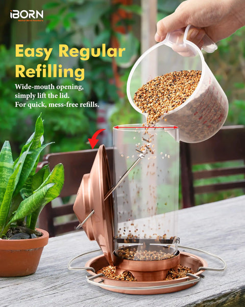 Chew Proof Metal Bird Feeder with Copper Finish being refilled outdoors. Features wide-mouth opening and weather-resistant design.