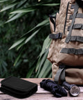 Tactical Survival Sewing Kit With Buttons, Durable Nylon, Compact, shown with rope and flashlight beside a backpack