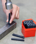 Hand using Number And Letter Punch Set With Heat Treated Steel Punches For Imprinting And Arts And Crafts For Hobbyists One Quarter Inch Shaft