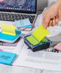 Hand using Burst Of Color Sticky Notes Refills 3x3 Pop Up Pads With 9 Bright Colors, Strong Adhesive Memo Pads For Home Office School.