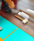 Worker using UHMW Tapping Block Three Pack Rectangular Solid Plastic Blocks for flooring installation, showing durable non-marring tools.