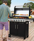 Man grilling on Six Burner Propane Gas Grill With Infrared Sear Side Burner And Diamond Pattern Cast Iron Grates And Griddle Built In Storage Cabinet And Side Table The Ultimate Backyard Barbecue Station For Juicy Steaks And Big Grilling Sessions