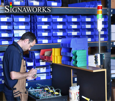 Engineer working near 5 Stack LED Andon Tower Light With Red Amber Green Blue White LEDs, 8 Ft Industrial Power Cord, Plug And Play Indoor Signal Tower, OSHA Standard, Easy Setup With Switch Box And Pole.