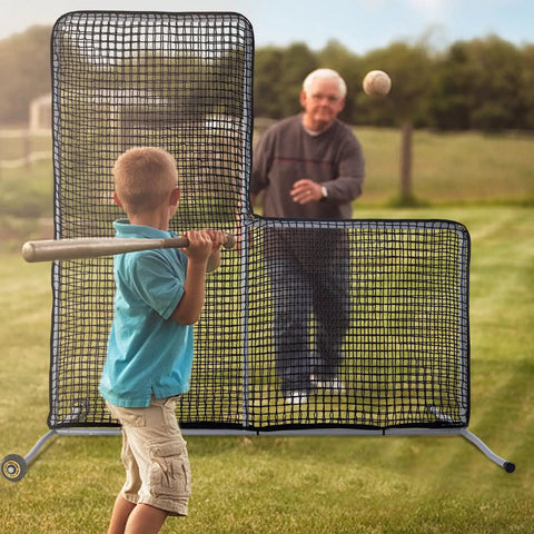 Child batting in front of L Screen Baseball Pitching Net With Wheels, 7x7 Ft Heavy Duty Portable Steel Frame outdoors