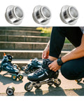 Aluminum Inline Skate Bearing Spacers Set Of 10 For 8mm Axles next to person lacing rollerblades outdoors
