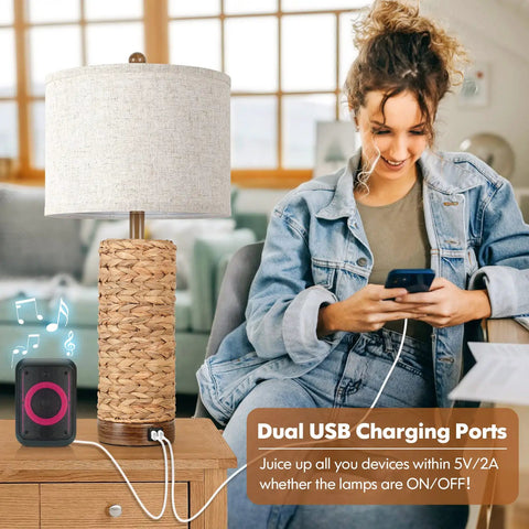 Woman using phone beside Set Of 2 Rattan Table Lamps For Living Room With USB Ports, 27 Inch Tall Rustic Seagrass Bedside Lamps