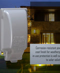 Tough As Nails One Gang Weatherproof In Use Outlet Cover With Fo Sho Quick Fit Keyhole Mount For Exterior Walls Extra Duty Rated Gray Housing mounted against a house backdrop.