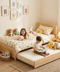 Solid Pine Twin Bed Frame With Pull Out Trundle, Rock Solid Platform Sleep Setup With Attached Headboard And Footboard, Space Saving Guest Ready Alternative For Kids And Teens, Natural Wood Finish in a cozy children's room.