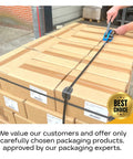 Worker using Heavy Duty Strapping Cart And Dispenser For PET Polyester Banding on stacked cardboard boxes.