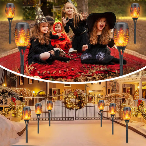 Eight Pack Solar Flickering Flame Torches for Outdoors with children in costumes on a red blanket in a garden setting
