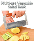 French fry slicer with wooden handle and stainless steel blades slicing potato on cutting board