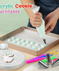 Acrylic Cookie Decorating Kit with turntable and piping bag creating mint green icing peaks on a tray.