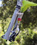 Hydraulic Bike Brake Bleed Kit For Avid, Formula, And Hayes Dominion With 2 Syringes, 2 Hose Fittings, DOT 5.1 Fluid, And Fasteners At Home Master Kit For Pro Grade Braking And Big Bucks in use with a mountain bike.