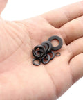 Hand holding various sizes of the 400 Piece Washer Kit With Flat And Spring Lock Washers In M3 M4 M5 M6 M8 Sizes, Carbon Steel Black Finish.