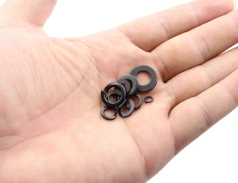 Hand holding various sizes of the 400 Piece Washer Kit With Flat And Spring Lock Washers In M3 M4 M5 M6 M8 Sizes, Carbon Steel Black Finish.