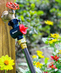 Inline Water Filter For Garden Hoses And Tools Anti Rust Stainless Steel 50 Mesh Screen attached to outdoor faucet with flowers