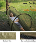Two In One Pop Up Hammock Tent With Mosquito Net For One Person with a breathable mesh and dual zippered easy access in a grassy area.
