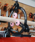 Side-view of BMWOOD MC-FS7 steady rest for 12–16 inch swing lathes; black metal frame with pink wheel guides.