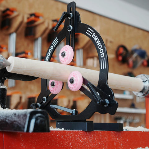 Side-view of BMWOOD MC-FS7 steady rest for 12–16 inch swing lathes; black metal frame with pink wheel guides.
