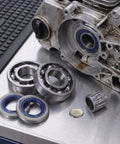 Chainsaw Crank Bearing Seal Kit For Husqvarna HUS357 359 357XP with needle bearings and oil seals on metal surface