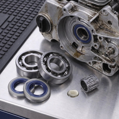 Chainsaw Crank Bearing Seal Kit For Husqvarna HUS357 359 357XP with needle bearings and oil seals on metal surface