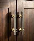 Two brushed nickel and gold cabinet handles from 10 Pack Brushed Nickel And Gold Cabinet Handles And Drawer Knobs Set on dark wood doors.