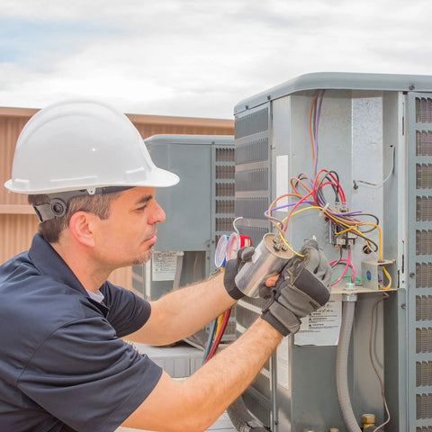 Technician installing 60/5 MFD Run Capacitor For AC Motors And HVAC Systems 370 To 440V CBB65 Direct Replacement