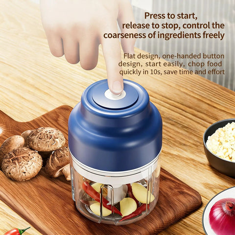 USB Rechargeable Mini Food Processor 320ML With 6 Stainless Blades Electric Garlic Chopper being operated with a finger on the button.