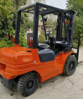 Heavy Duty Rough Terrain Forklift Truck Powered By Clean Electric Motor Straight Up Built Different For Outdoor Construction Sites Featuring Solid Three Ton Capacity And Wide Pneumatic Tires parked on site.