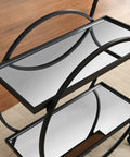 Close-up of the Modern Black Two Tier Bar Cart With Mirror Trim And Metal Frame, showcasing mirrored surfaces.