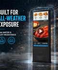 55 Inch Outdoor Digital Signage Kiosk With 3000 Nits Sun Crushing Lcd Display Ip66 Waterproof Rock Solid Frame Vandal Resistance Tough As Nails Panel Runs Around The Clock For Business Marketing in rain, showcasing bright seafood menu.