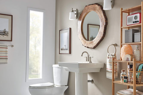 Westchester One Handle Bathroom Faucet Brushed Nickel in a modern rustic bathroom with a circular mirror and white sink