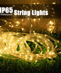 Solar Rope Lights Outdoor 72 Feet 200 LED Waterproof Copper Wire Fairy Lights coiled on grass with IP65 label in rain