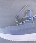 Upgrade Your Daily Drip With Top Tier Metal Alloy Shoe Lace Tips on light blue trainer shoe with grey laces.