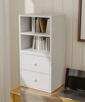 Stackable Cube Storage Organizer For Home And Office DIY Modular Shelving Cubes For Books Clothes Toys And Decor Built With Sturdy 18mm Panels Hidden Bolts Anti Tip Kit Mortise And Tenon Joints Free Stacking Design In White Washed Finish on a desk with books and decor