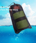 Mesh bag containing DSMB Kit For Scuba Diving With Five Foot Tube And Ninety Eight Foot Reel Marker Buoy over ocean water